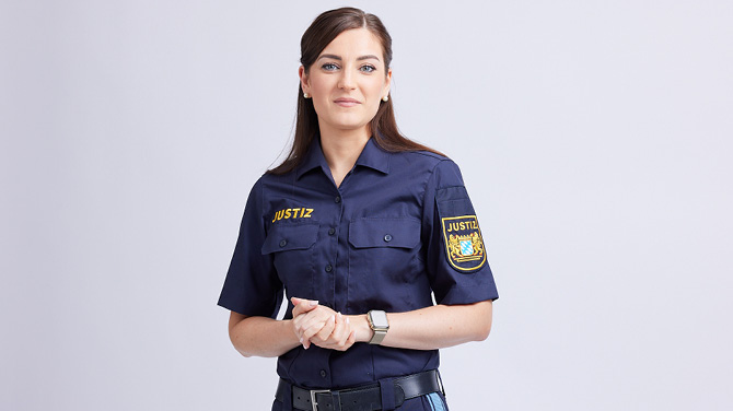 Isabelle A. legt die Hände ineinander und lächelt in die Kamera.
